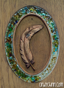 hand carved feather with glass sig