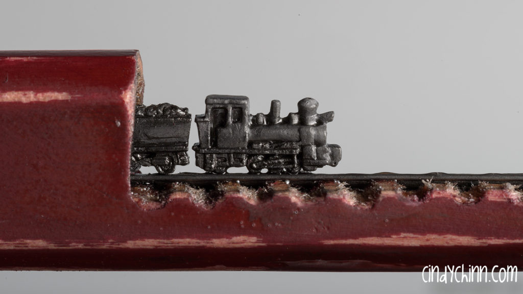 Train carved from a pencil lead by Cindy Chinn - Aggie Express