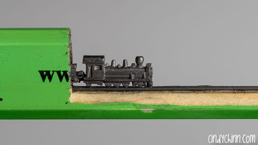 Train carved from a pencil lead by Cindy Chinn - Marvic Express