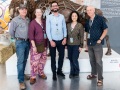 Artist post in front of artwork