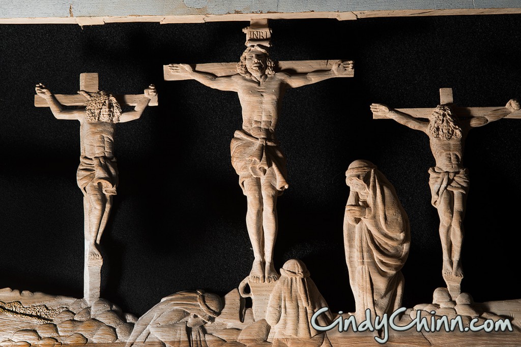 Crucifixion carving on pew
