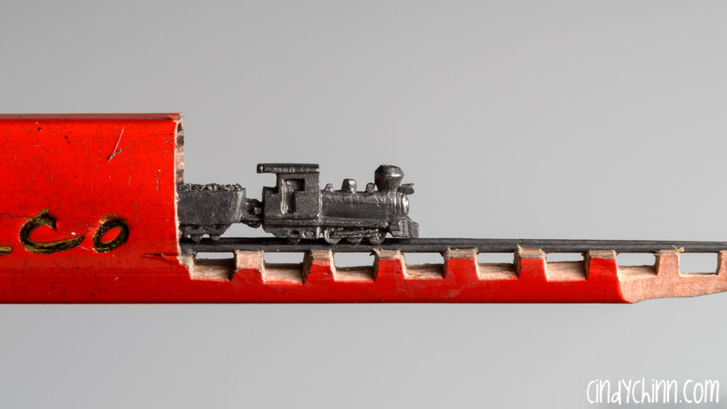Train carved from a pencil lead by Cindy Chinn